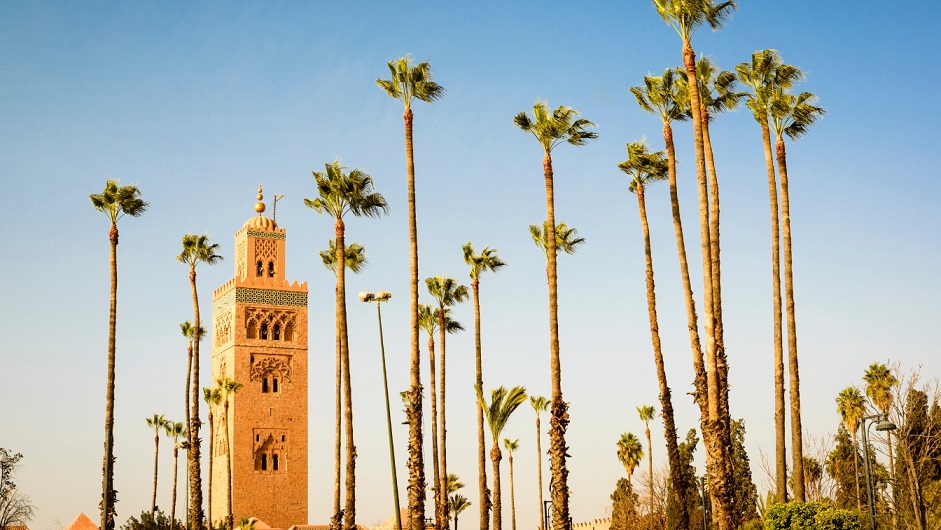 Koutoubia minaret in Marrakech with palm trees