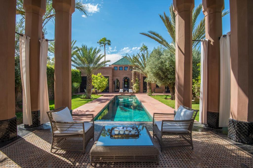 Beautiful palms and swimming pool at Selman Marrakech